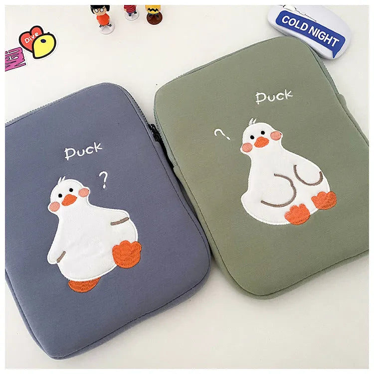 Blue cotton tablet case with embroidered cartoon duck design and a zipper.