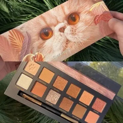 Explorer twelve-colour animal eye shadow palette open, showing pressed powder shades including cat, golden tiger and red fox.
