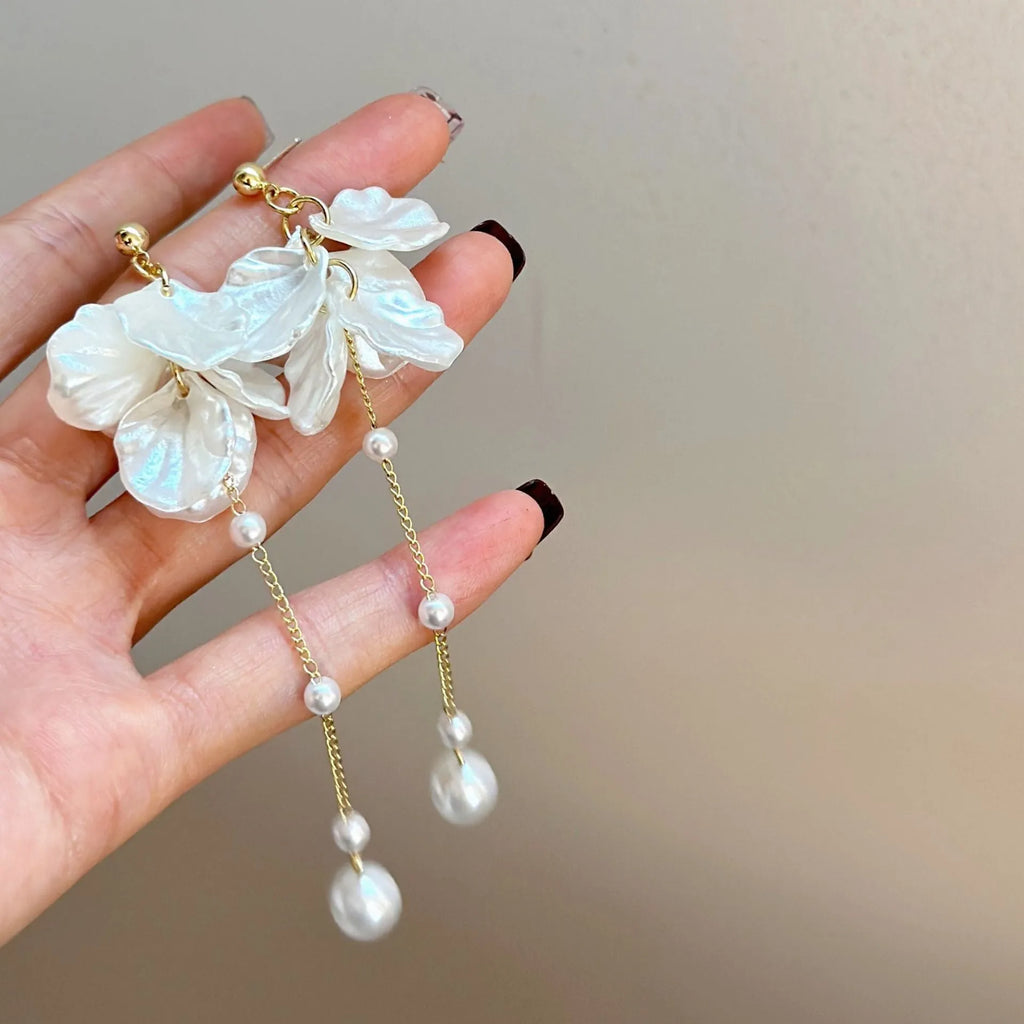 Long shell pearl tassel earrings with acrylic construction and multiple ear clip options