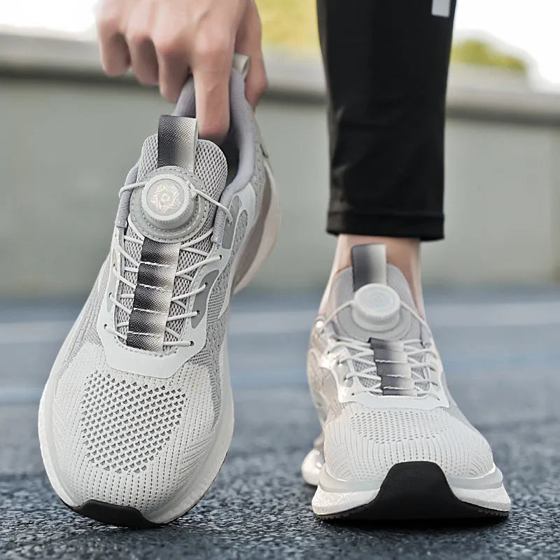 White low-top running shoes with a rotating buckle closure and Fly-knit mesh upper.
