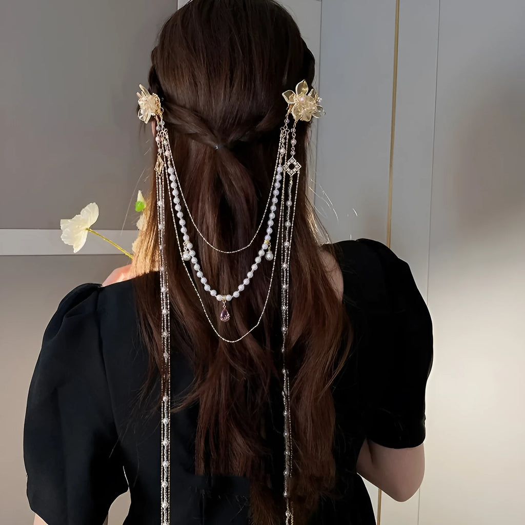 Gold grip hairpin for women with pearl, diamond, flower decorations and a long tassel.