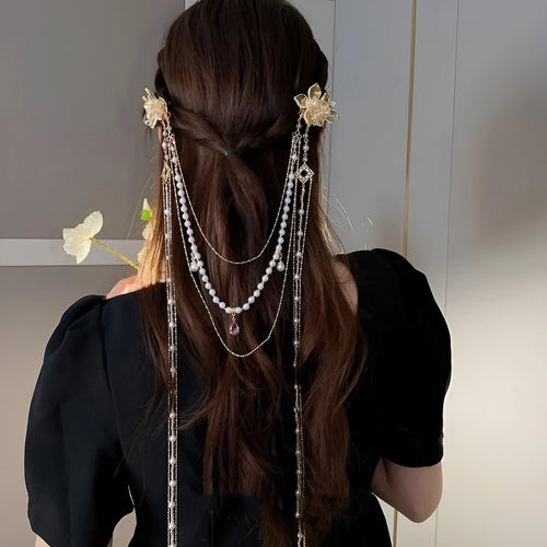 Gold grip hairpin for women with pearl, diamond, flower decorations and a long tassel.