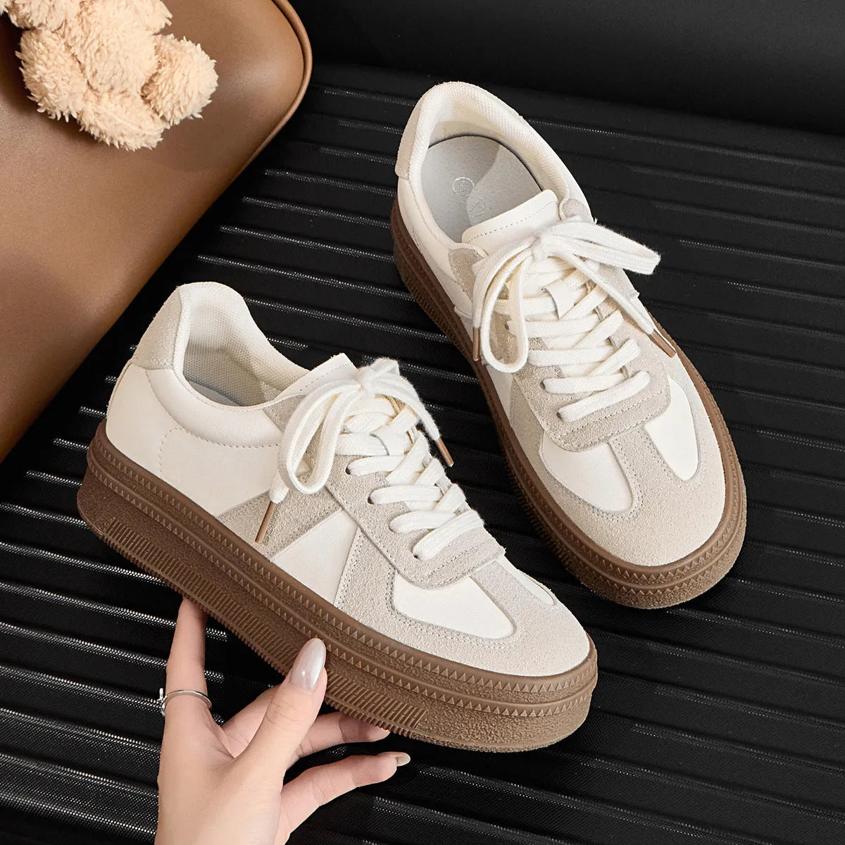 Retro sports shoes with round toe, cross straps, and lace-up front in milky white colour