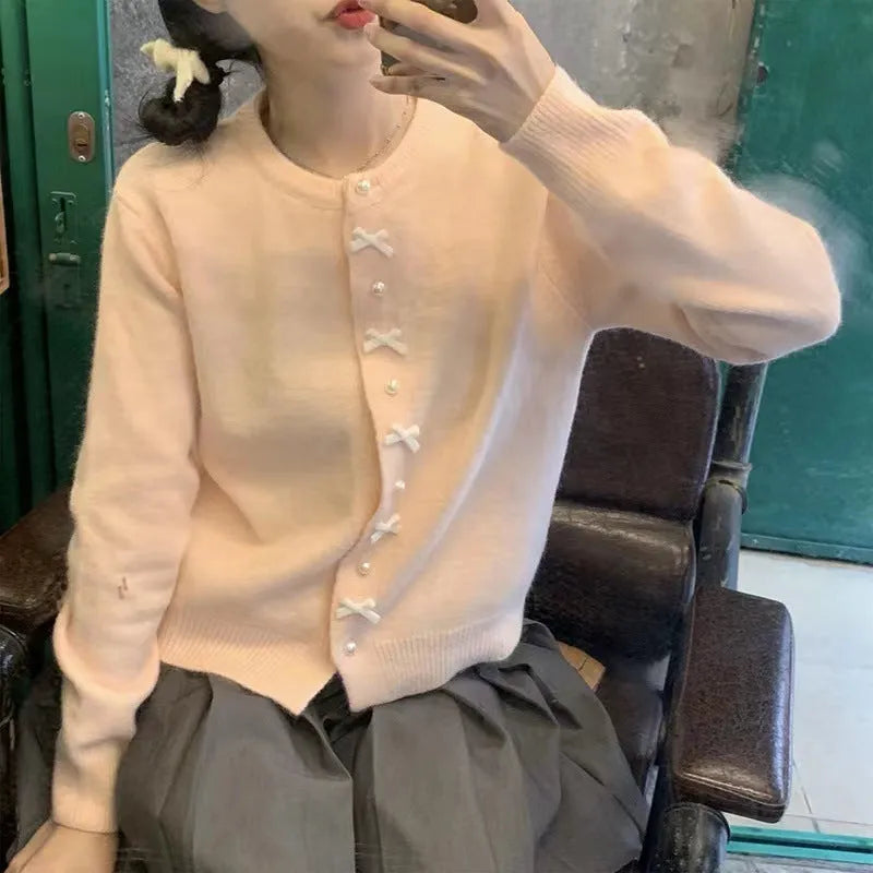 Women's acrylic cashmere cardigan sweater with bow and pearl button detail in nine colour options