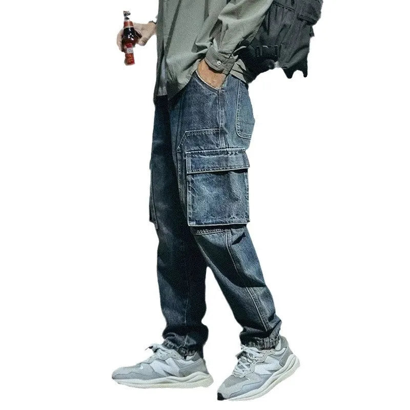 Blue men's loose straight-leg stretch denim trousers on a hanger