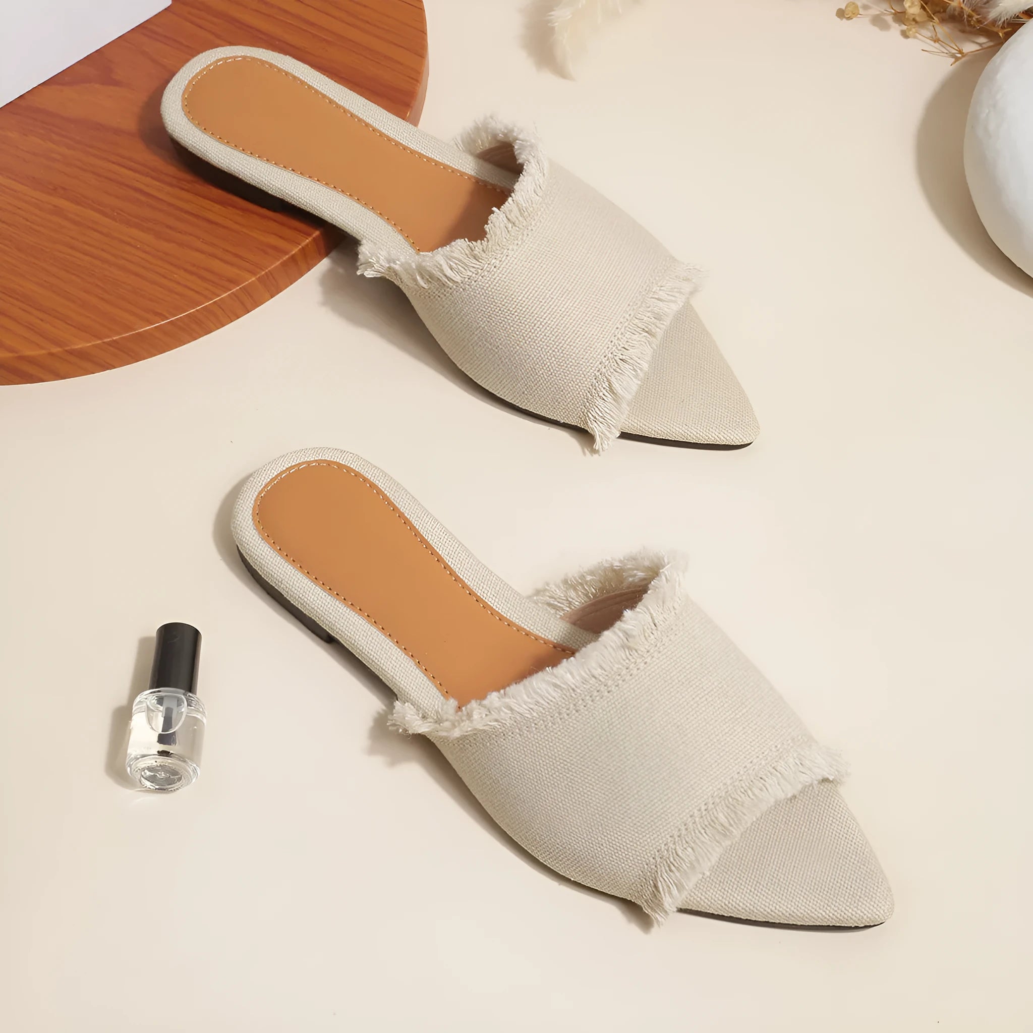 Women's denim casual flat slippers with a tassel detail in multiple colour options.
