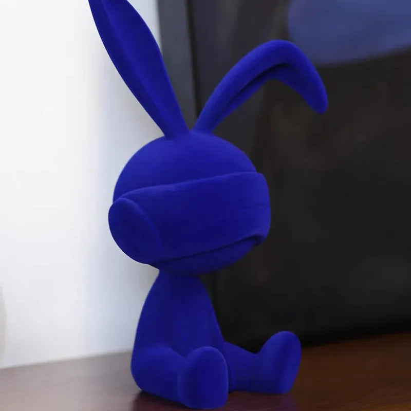 Small resin rabbit table ornament with a suede blindfold, shown in green, blue, and red colour options.
