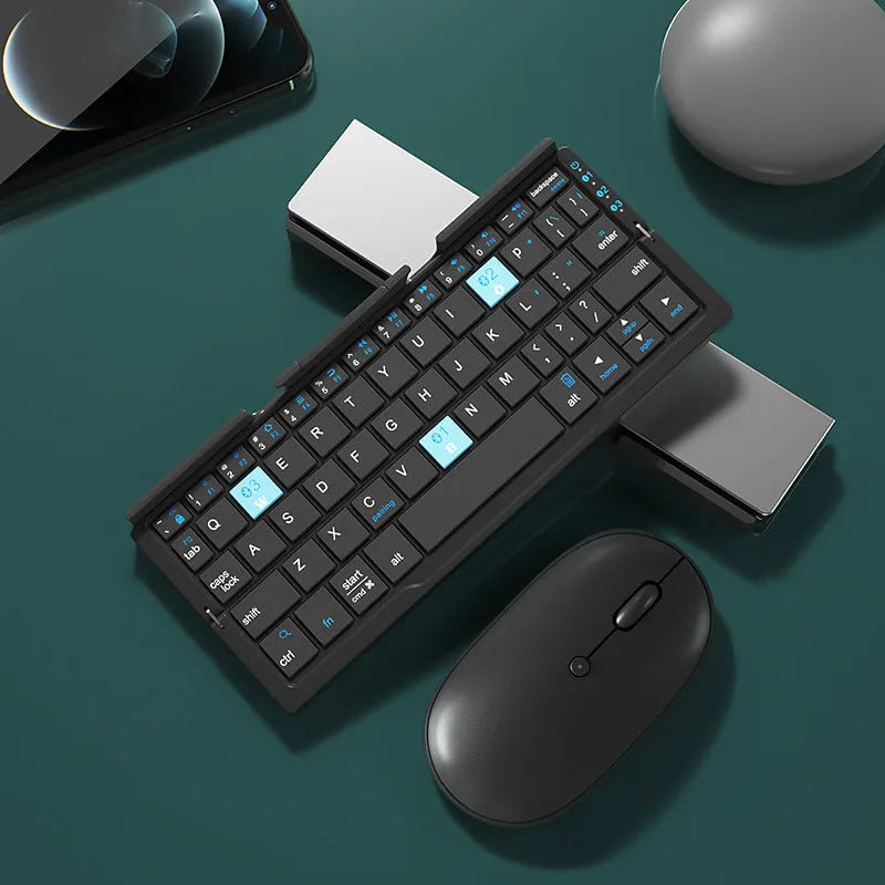 Silver aluminium folding Bluetooth keyboard open with smartphone propped on integrated stand