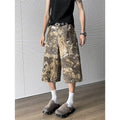 Yellow snake pattern camouflage cropped jeans on hanger showing tooling detail