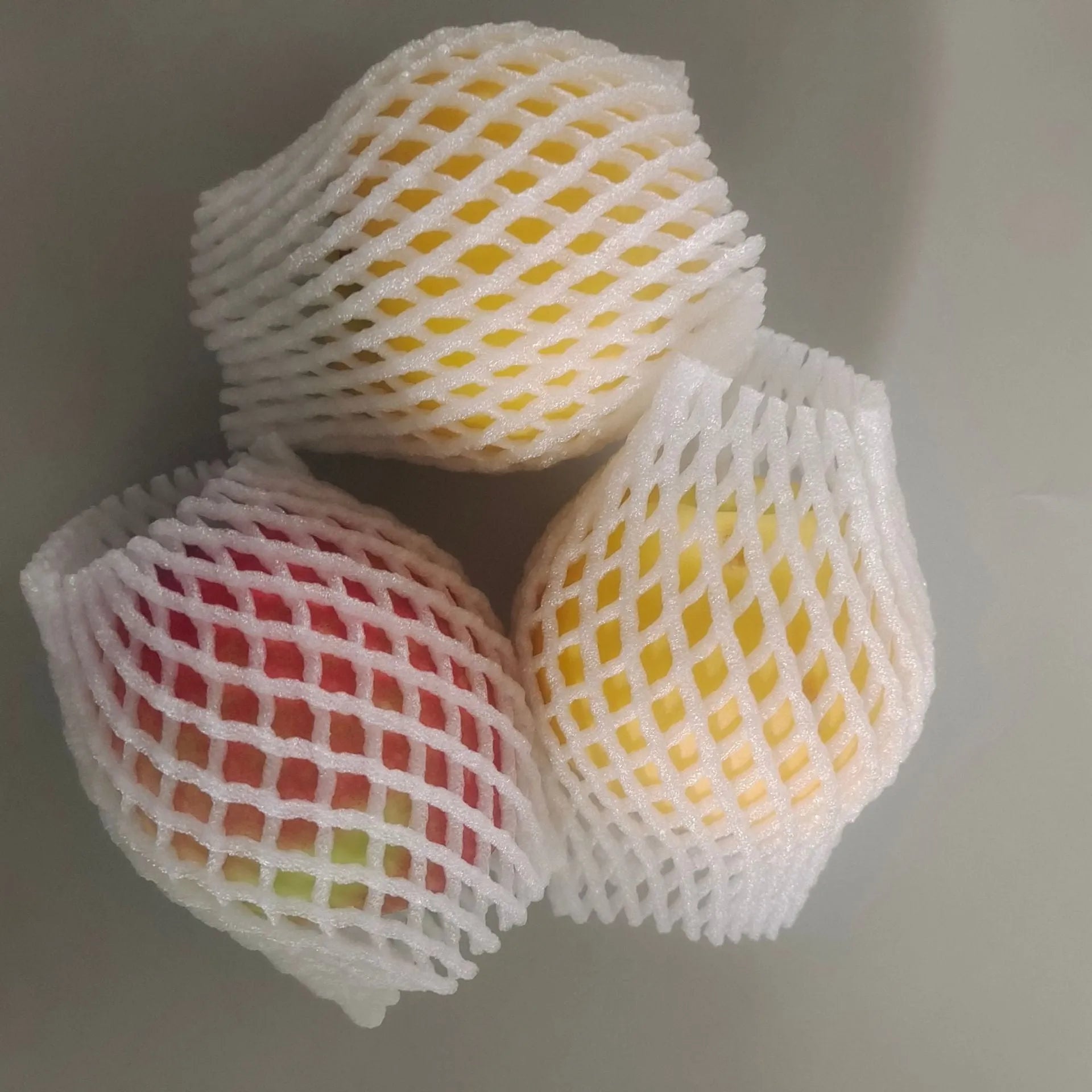 White foam shockproof protective net cover for fruit, shown in various sizes.
