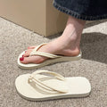 Men's PVC toe covering flip flops in beige on a plain background, showing non-slip sole.