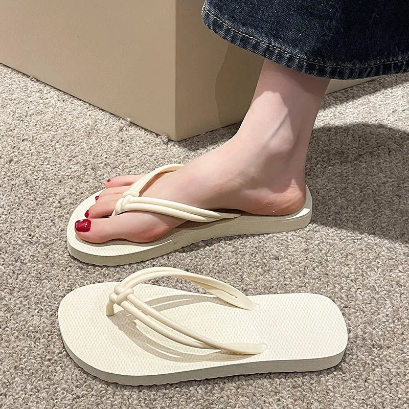Men's PVC toe covering flip flops in beige on a plain background, showing non-slip sole.