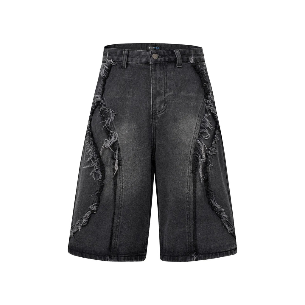 Distressed raw edge denim shorts in light blue, shown on a model.