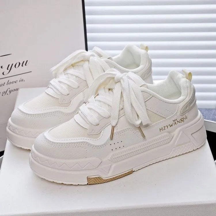Children's beige platform shoes with thick rubber sole, lace-up front, and cross shoulder straps.