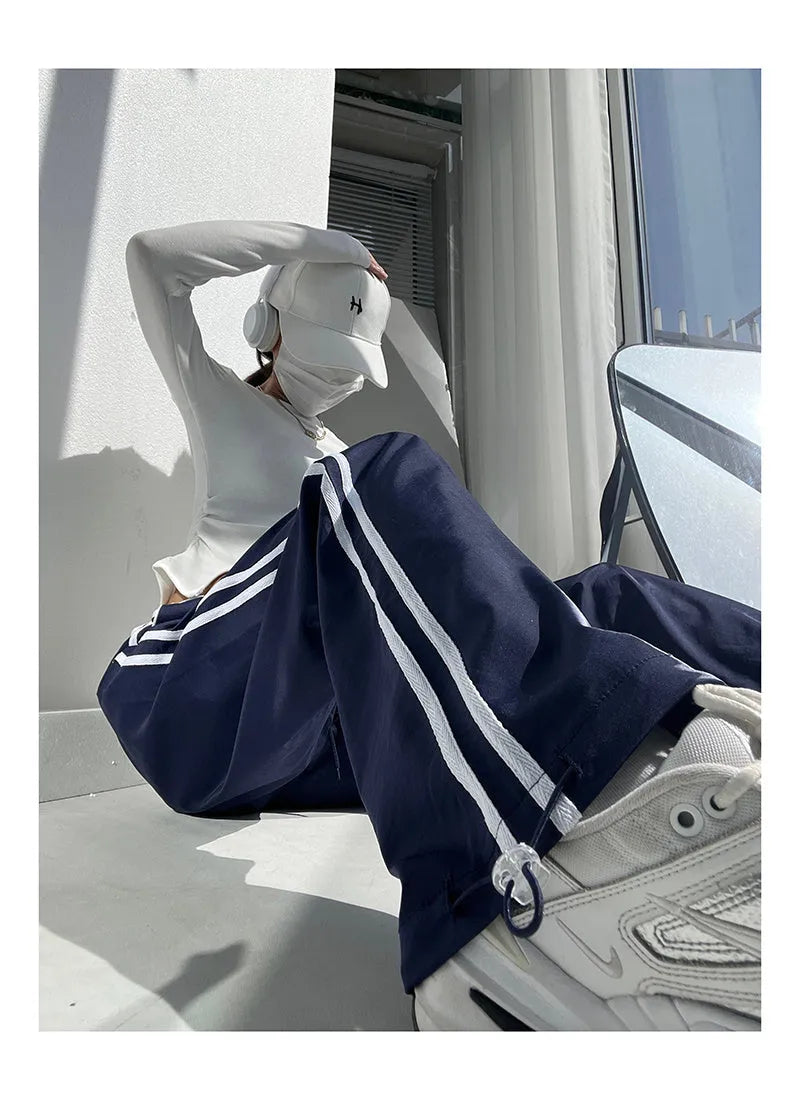 Women's straight leg trousers with ribbon waist and parallel bars contrast detailing in navy blue