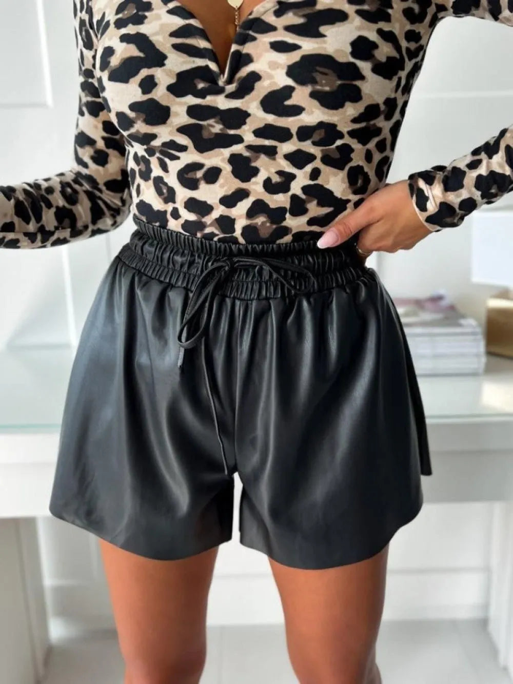 Women's black wide-leg shorts with a front lace-up drawstring waist detail.
