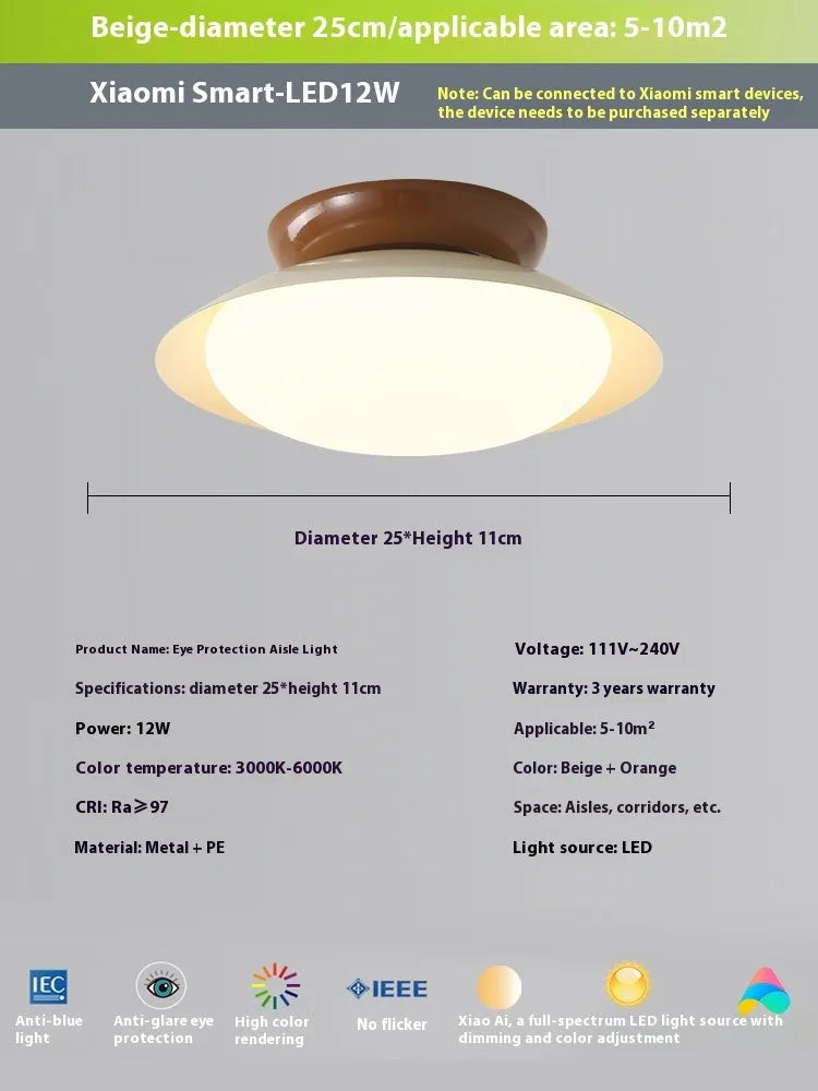 Modern cream-style flying saucer shaped ceiling lamp in a bedroom setting.