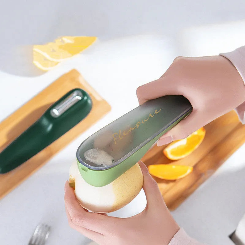 Green kitchen peeler with storage tube, stainless steel blade and hanging hole on handle
