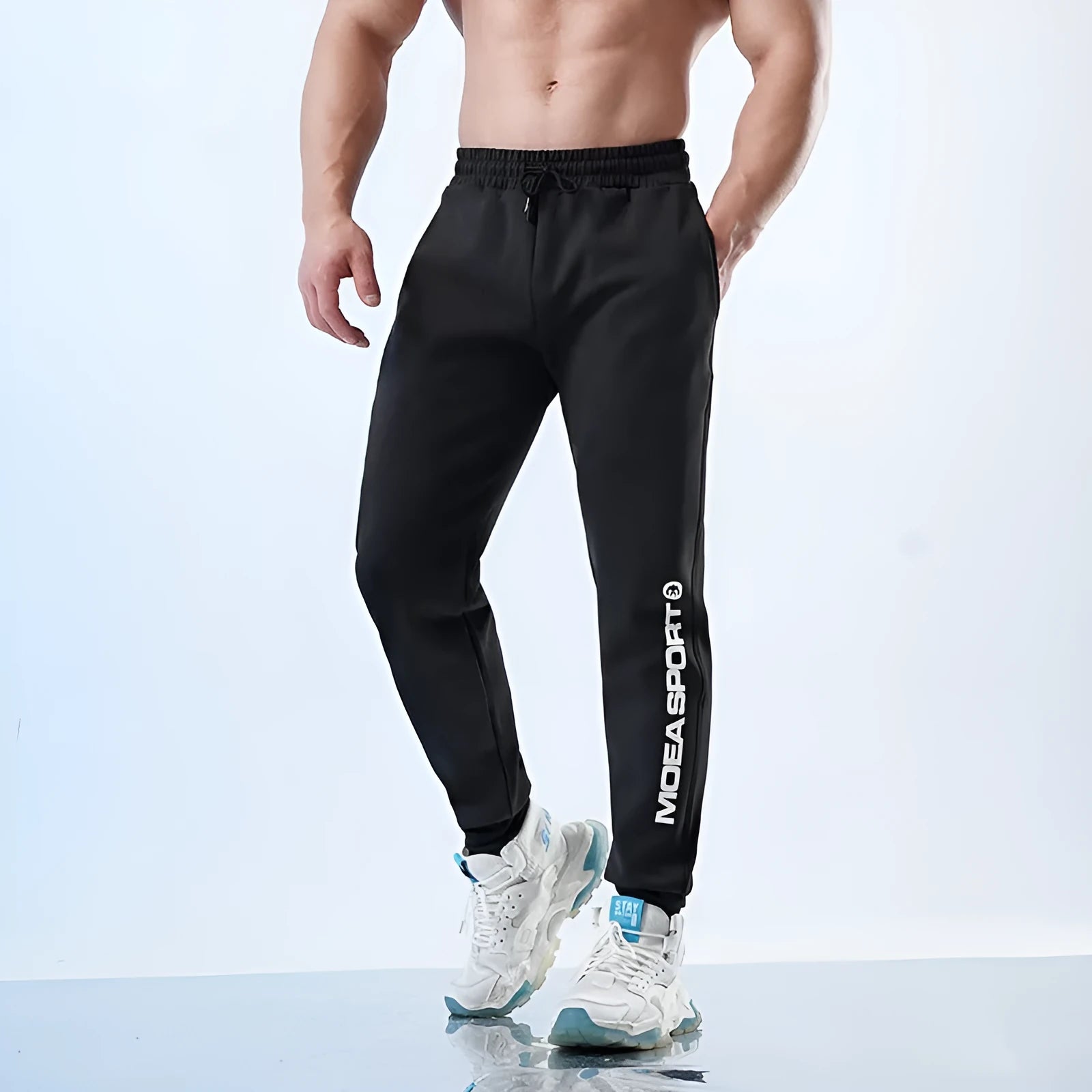 Men's black air layer ankle-tied sweatpants with mid waist design shown laid flat