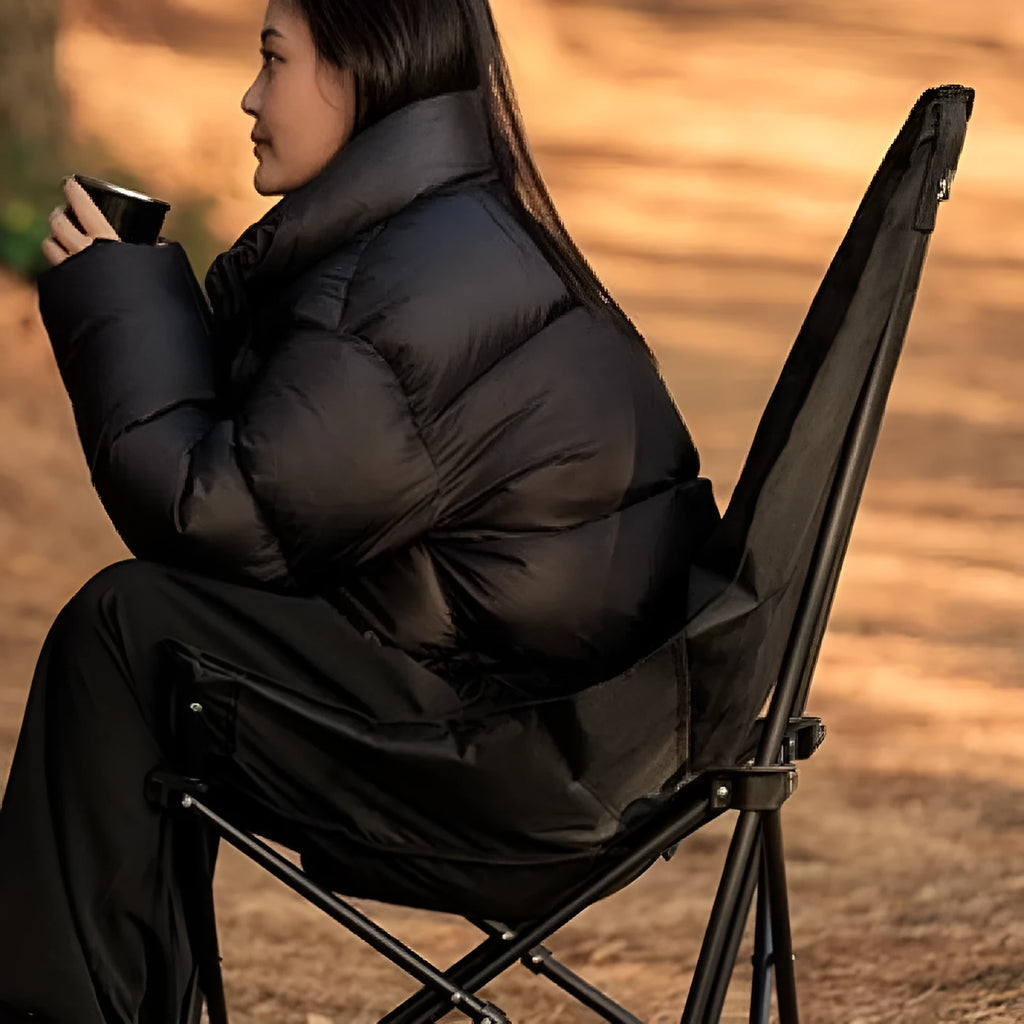 Night Black portable folding moon chair for outdoor camping and beach use.