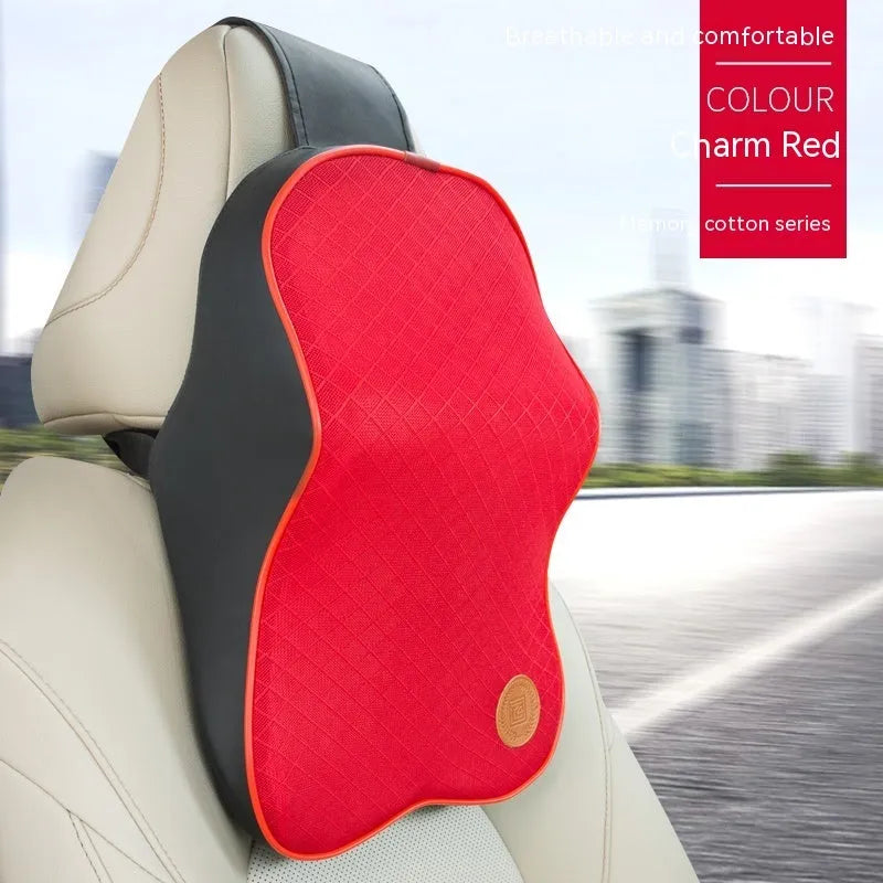 Black and brown memory foam car headrest and lumbar support pillows on a car seat.