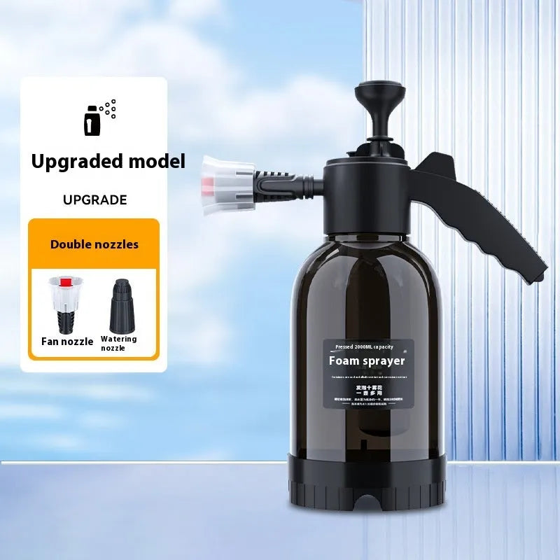 Black 2 litre handheld foam spray watering can with a comfortable handle and two nozzle attachments.