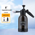 Black 2 litre handheld foam spray watering can with a comfortable handle and two nozzle attachments.