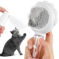 Grey spray cat brush with a release button and water tank for grooming pets.