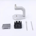 Silver coloured tool steel press strap removal tool for watch and jewellery repair on a dark surface.