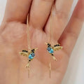 Bird hanging earrings with zirconium wings in long drop style