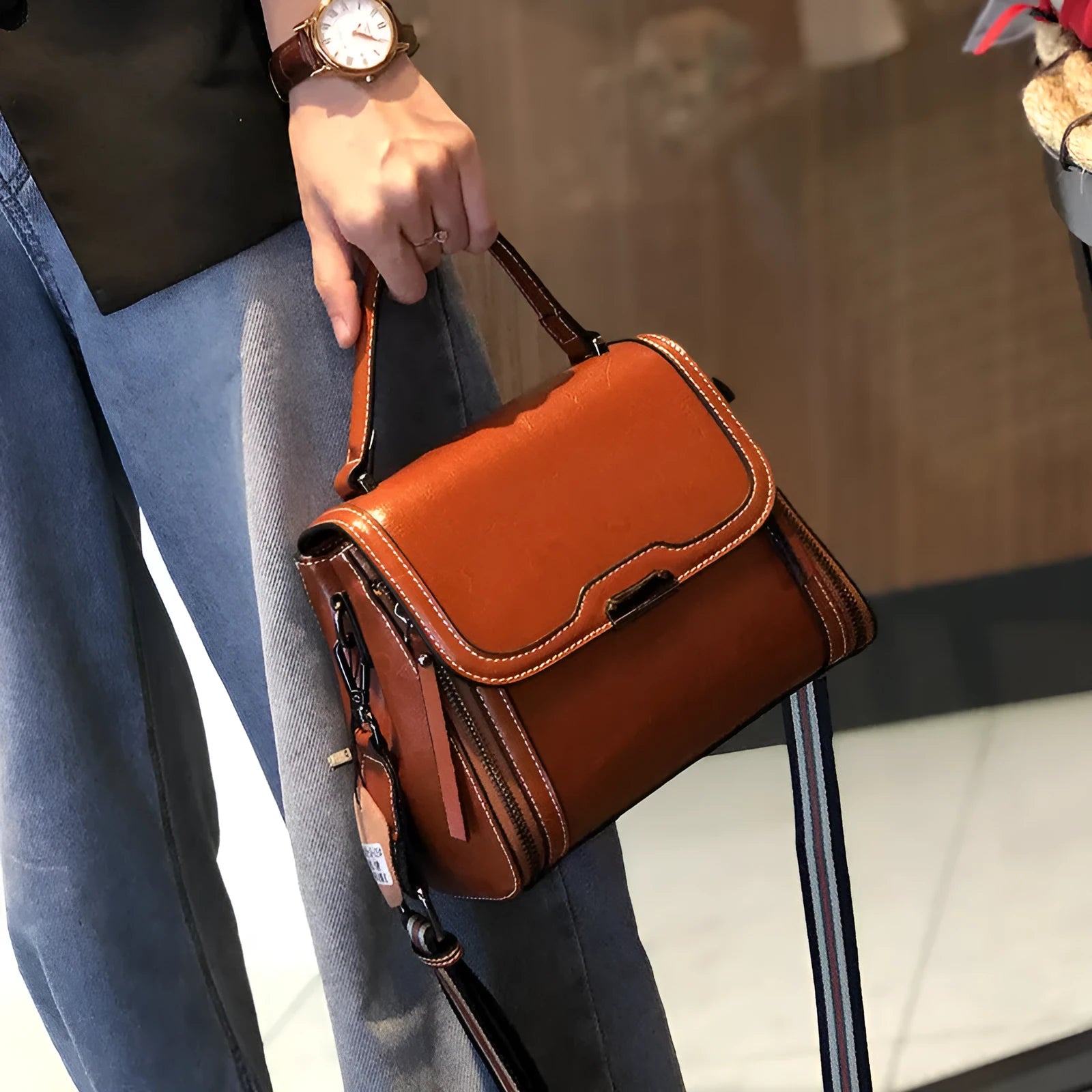 Women's brown genuine leather messenger bag with retro styling and multiple internal pockets