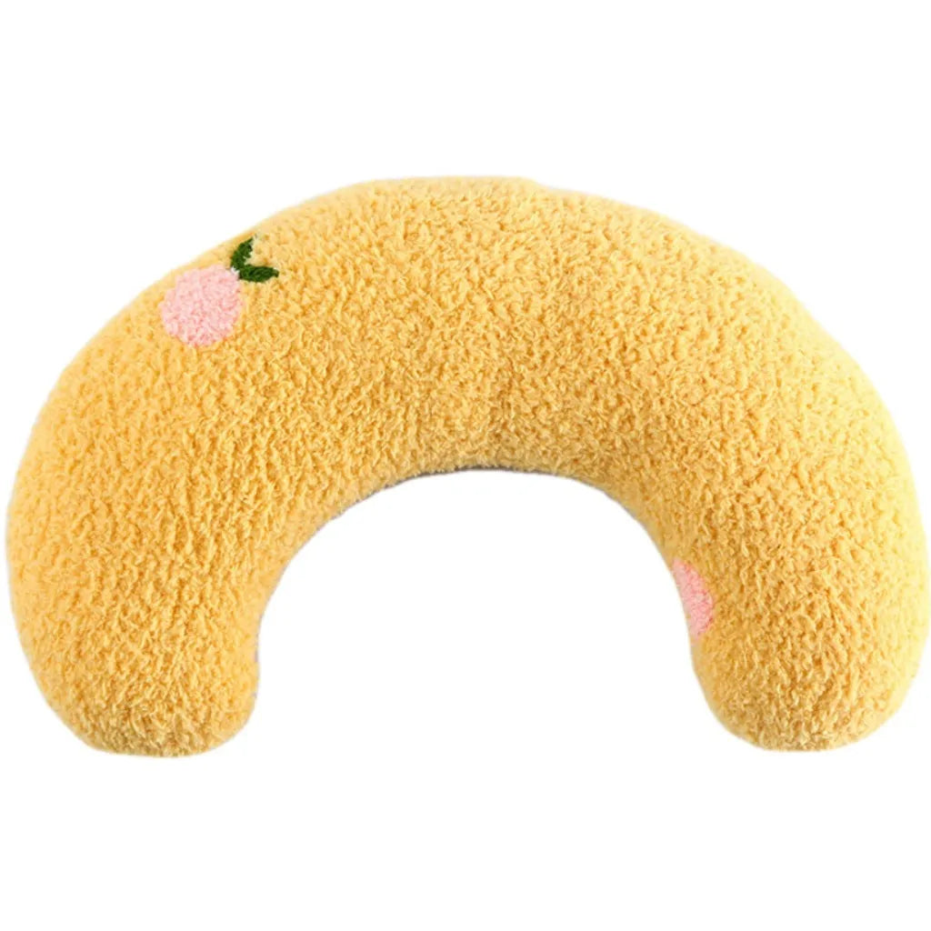 Small white U-shaped plush pet pillow for cats and small dogs on a neutral background.