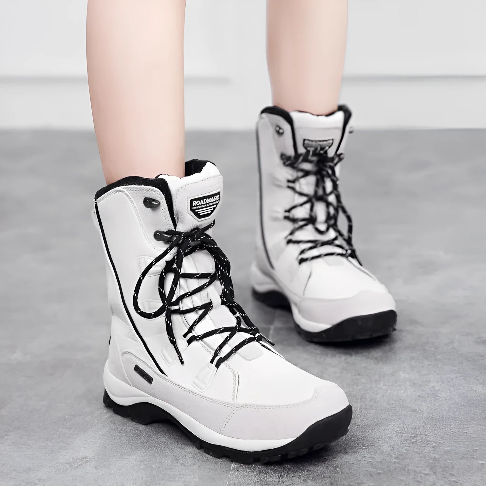 Women's black genuine leather mid-calf snow boots with round toe and rubber sole on a white background.