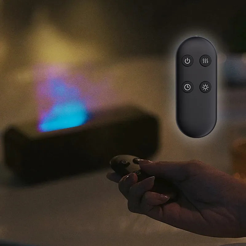 Black and white USB essential oil aroma diffuser with colour-changing light and remote control on a desk