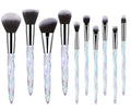 Set of 10 crystal-handled foundation brushes with synthetic bristles laid out flat.