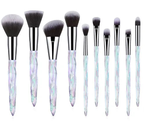 Set of 10 crystal-handled foundation brushes with synthetic bristles laid out flat.