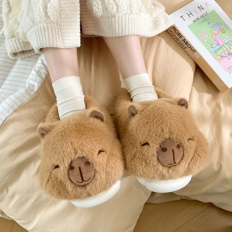 Light brown women's plush winter slippers with artificial wool lining and a PVC sole.