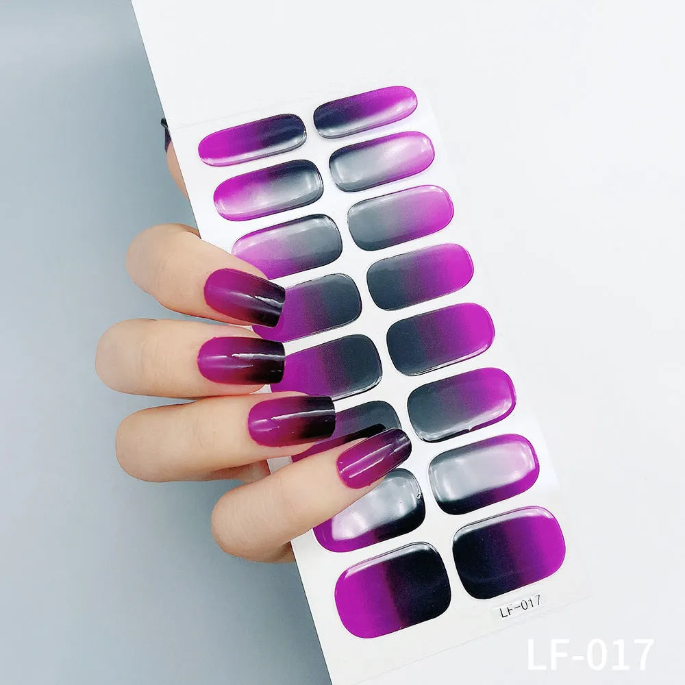 Set of 16 solid colour nail art stickers showing floral, geometric, and pattern designs for manicure application