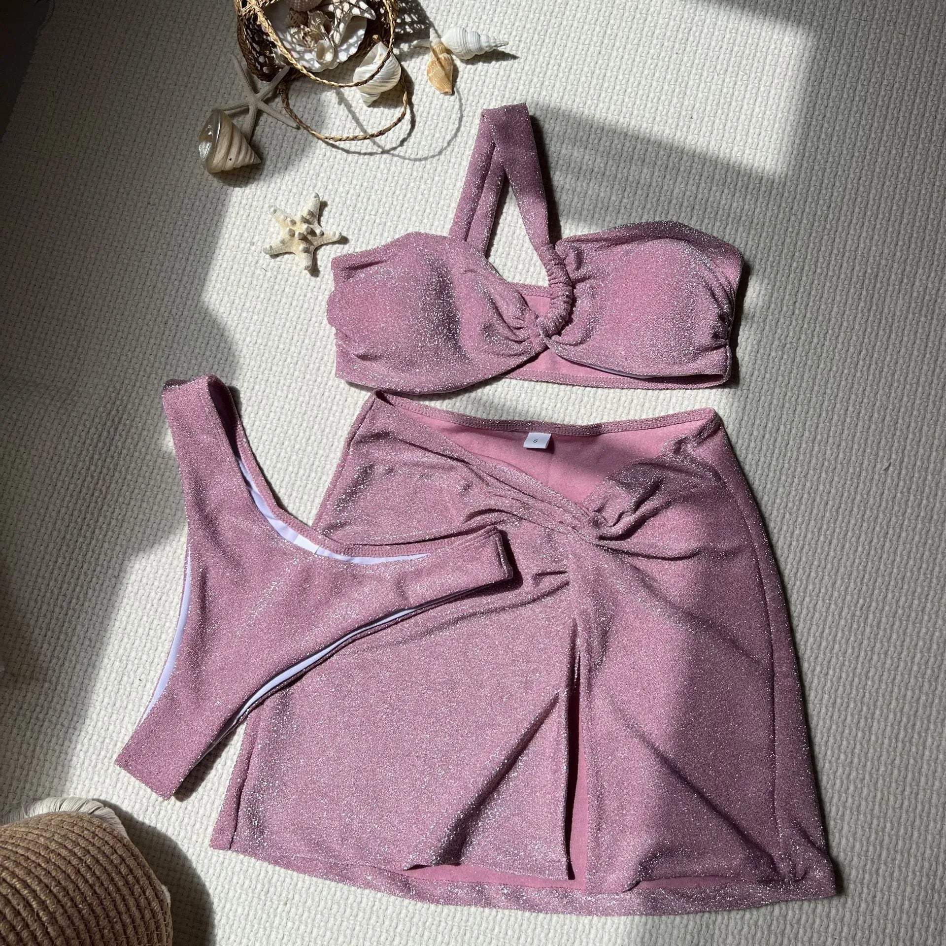 Women's one-shoulder tube top three-piece swimsuit set in glossy polyester fabric with matching skirt