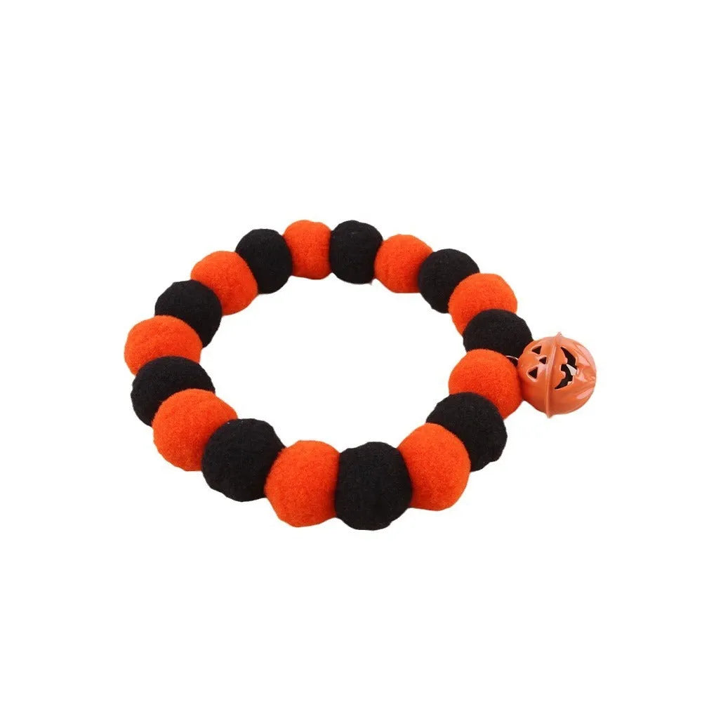 Orange Halloween pumpkin motif cat collar with an adjustable buckle fastener.