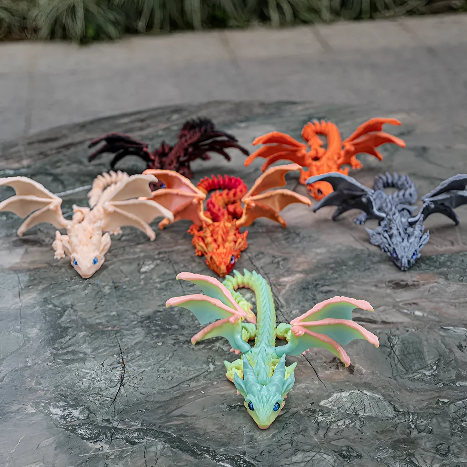 Red and gold 3D printed dragon wings toy decoration on a white background.