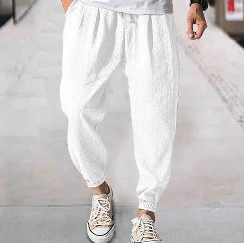 Men's loose casual cotton trousers with an elasticated ankle band in light green.