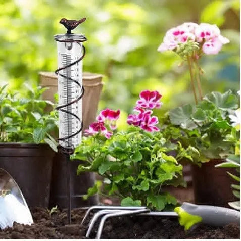 Traditional cast iron stand with bird-shaped glass rain gauge for garden precipitation measurement