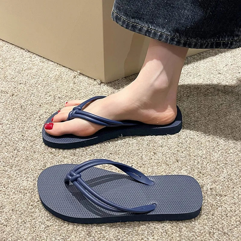 Men's PVC toe covering flip flops in beige on a plain background, showing non-slip sole.