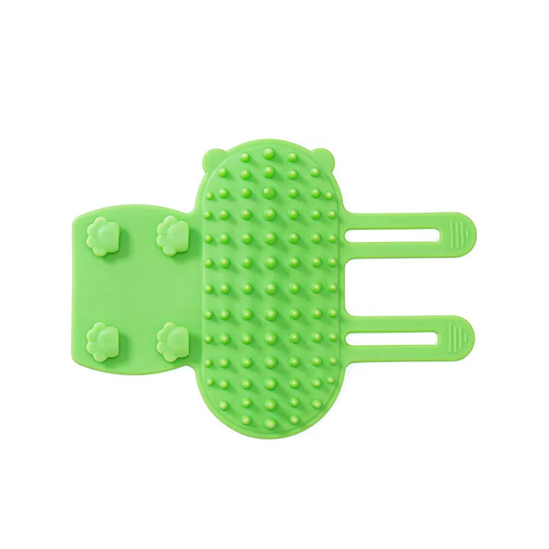 Silicone cat grooming comb with adjustable strap fastened to a table leg for self-cleaning