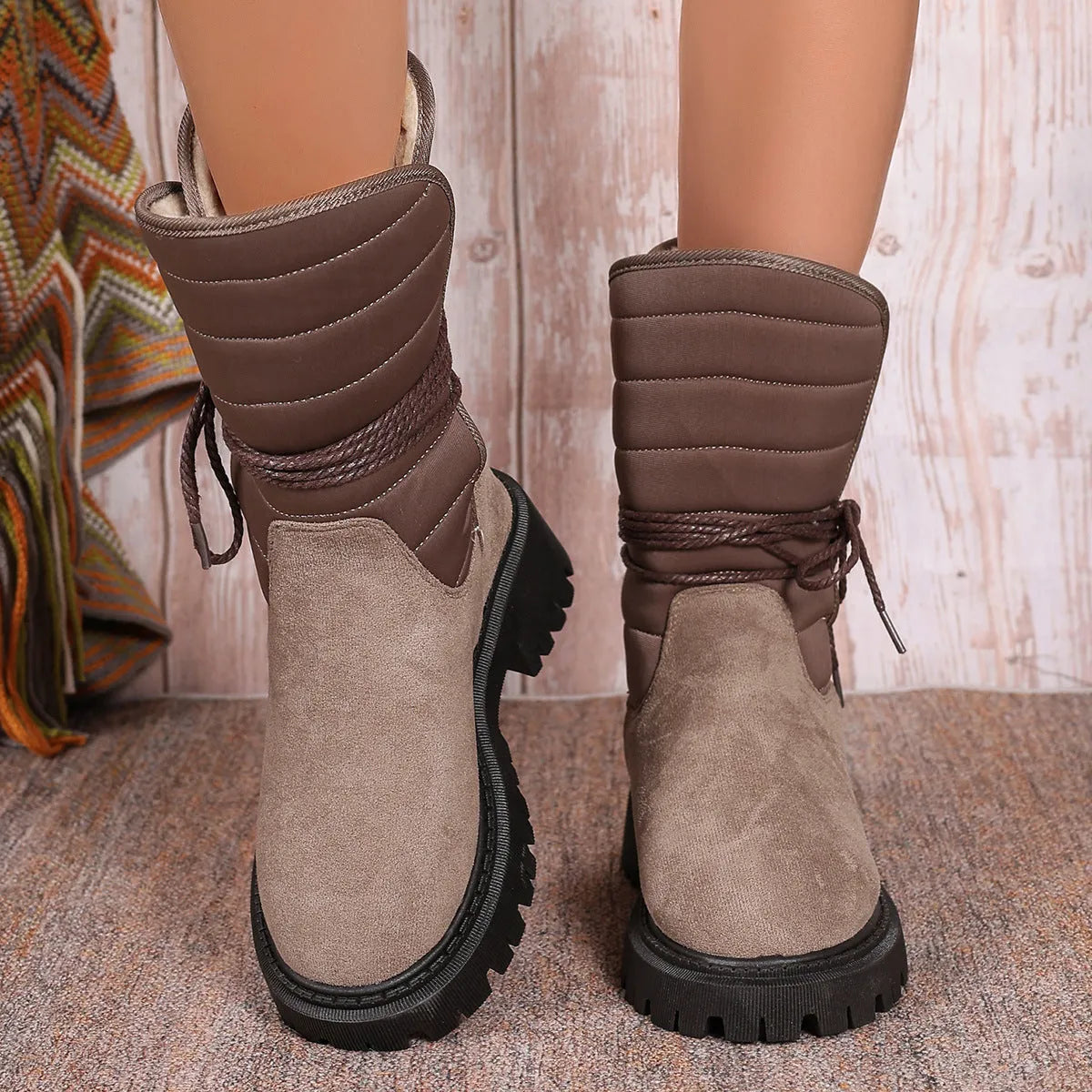Women's black chunky heel snow boots with lace-up design and fleece lining.
