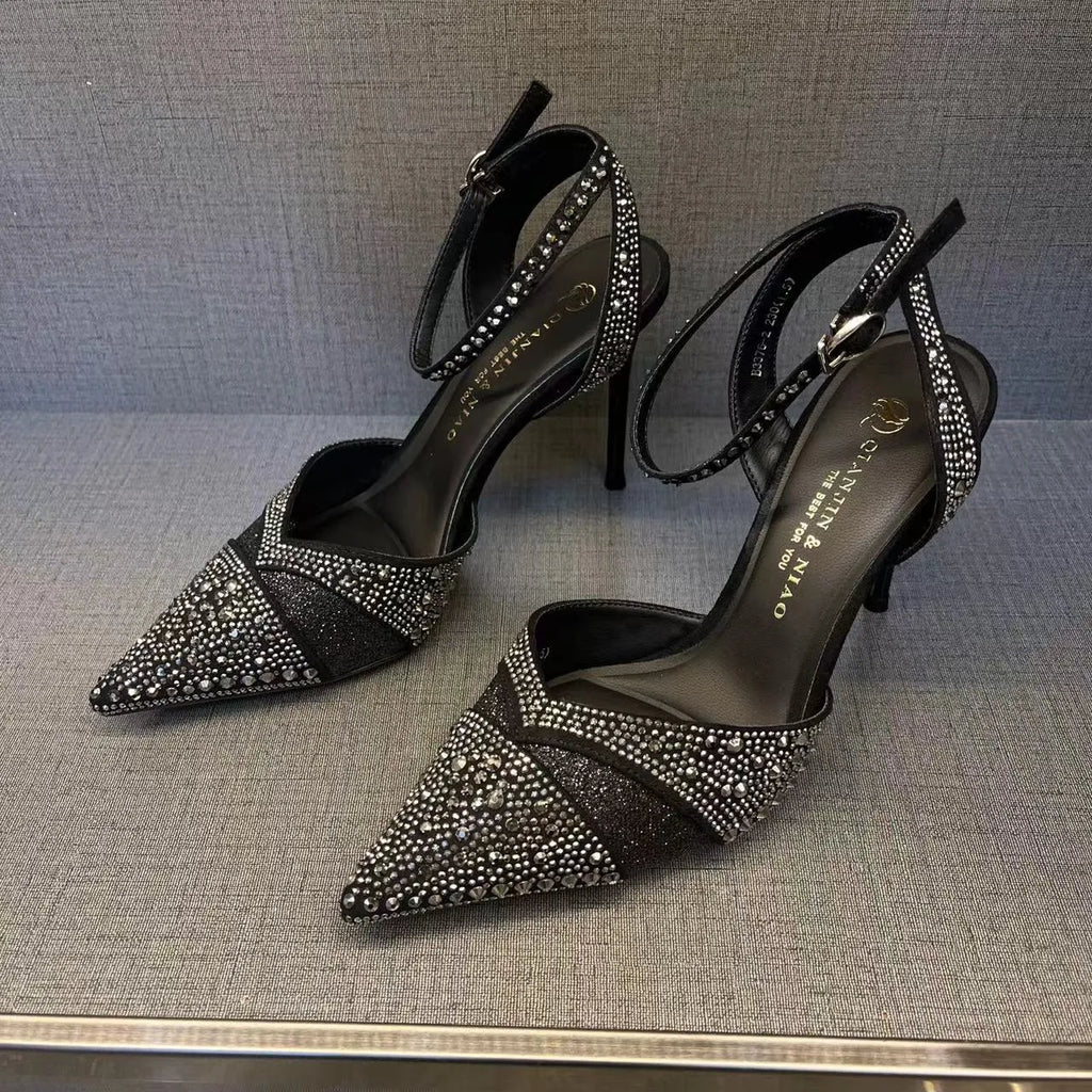 Women's black hollow high heels with red sole and pointed toe on a stiletto heel