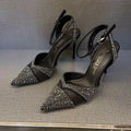 Women's black hollow high heels with red sole and pointed toe on a stiletto heel