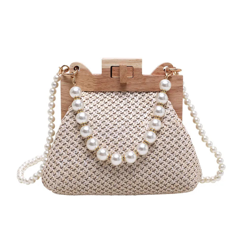 Women's straw woven shoulder bag with pearl chain strap in horizontal square shape showing internal organisers