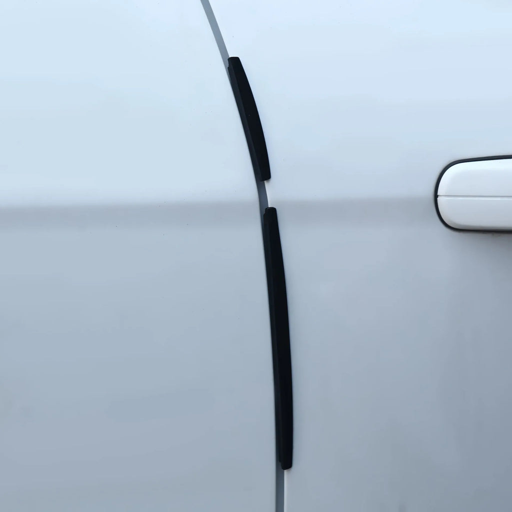 White plastic car door edge bumper strip on a vehicle door for anti-collision protection.